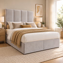 Dover upholstered divan storage bed and headboard in a modern bedroom, opposite three-quarter view