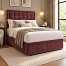 Rose burgundy upholstered divan storage bed with buttoned headboard in a modern bedroom, opposite three-quarter view