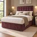 Rose burgundy upholstered divan storage bed with buttoned headboard in a modern bedroom, three-quarter view